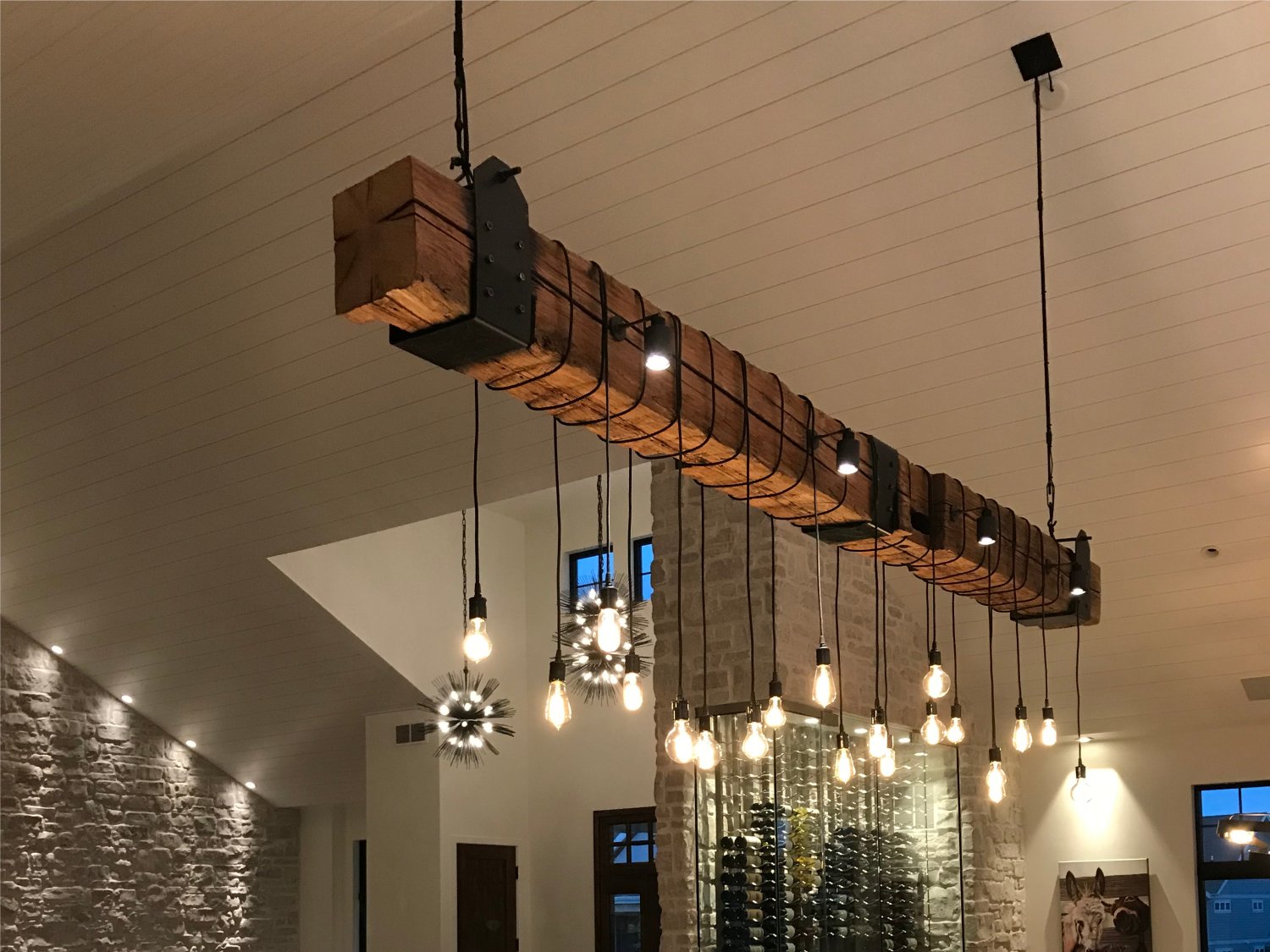 Rustic industrial wood beam chandelier with iron accents and Edison bulbs