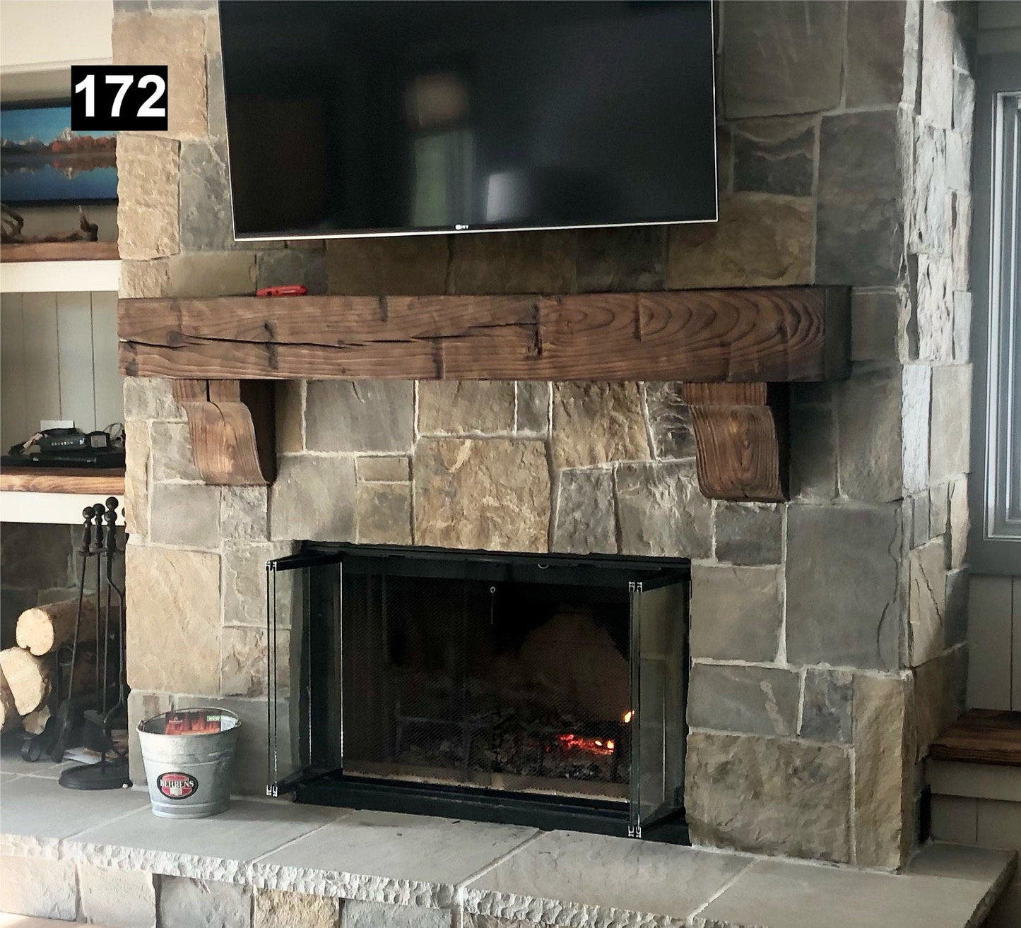 Custom reclaimed wood beam fireplace mantel with corbels